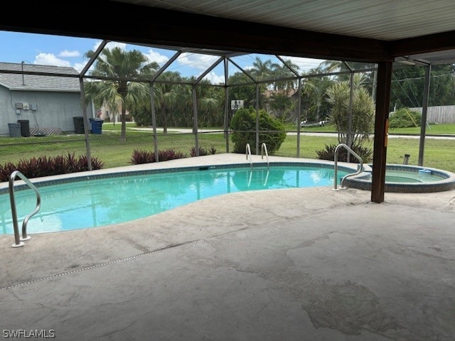 view of pool featuring a patio area, a lawn, and glass enclosure