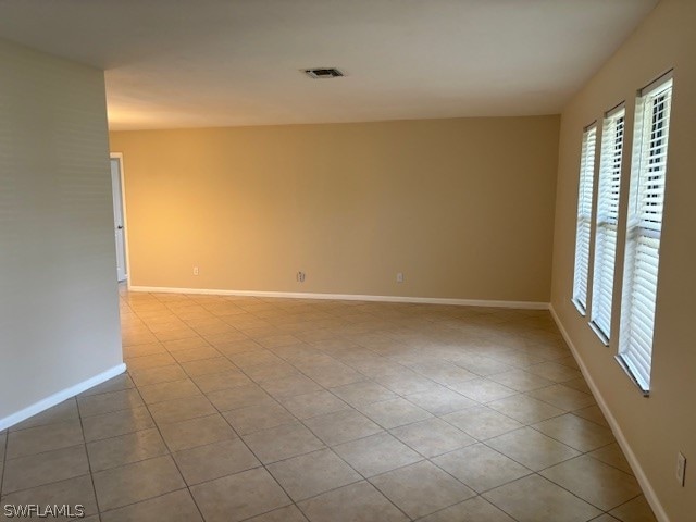 tiled empty room with a healthy amount of sunlight