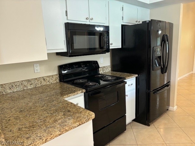 kitchen with light tile patterned flooring, black appliances, and white cabinets