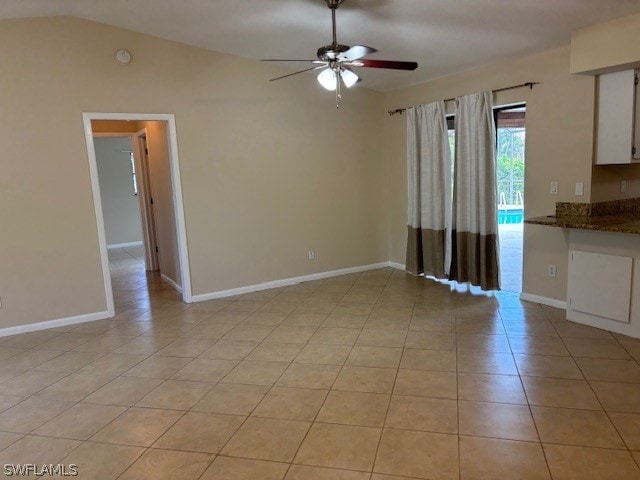 unfurnished living room with lofted ceiling, light tile patterned floors, and ceiling fan