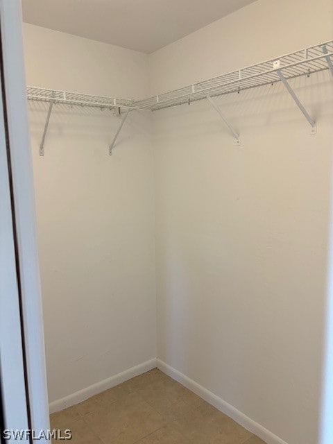 spacious closet featuring tile patterned floors