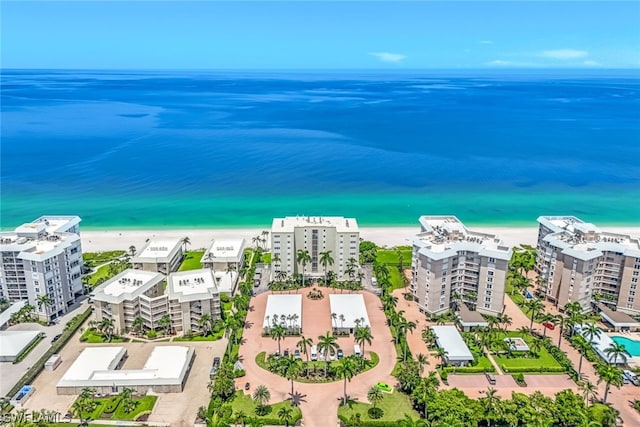 bird's eye view with a water view and a beach view