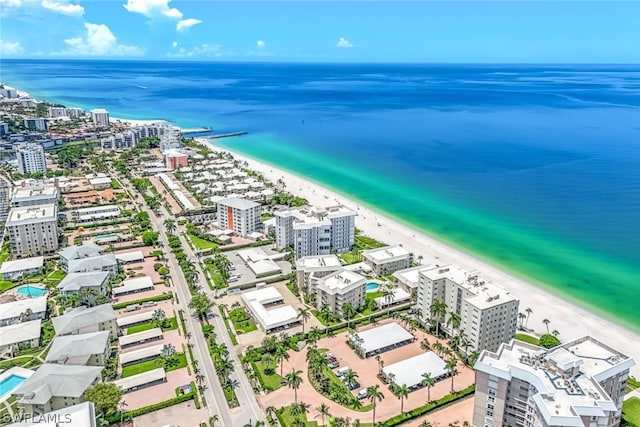 drone / aerial view featuring a water view and a beach view