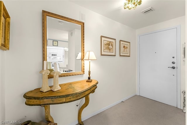 entrance foyer with light carpet