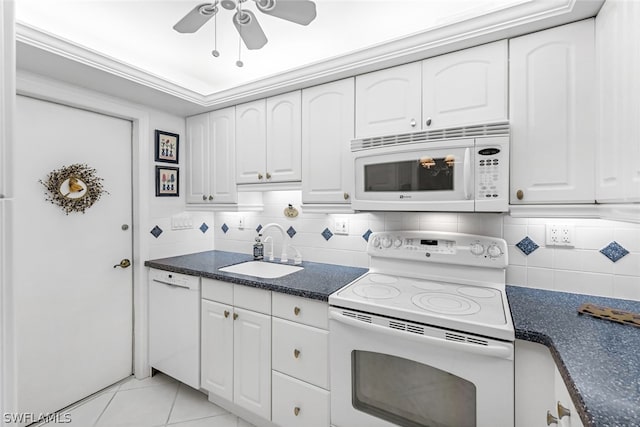 kitchen with white cabinetry, sink, and white appliances