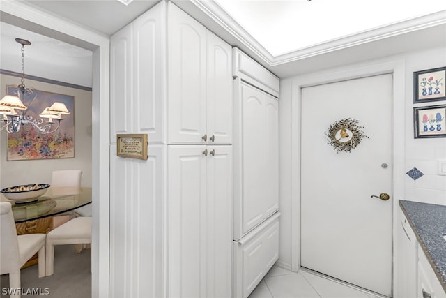 doorway with ornamental molding, light tile patterned flooring, a notable chandelier, and breakfast area