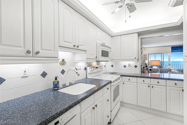 kitchen featuring sink, white appliances, light tile patterned floors, ceiling fan, and white cabinets