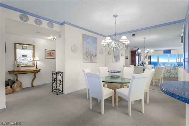 carpeted dining room with an inviting chandelier and ornamental molding