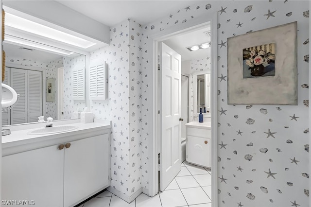 bathroom featuring tile patterned flooring and vanity