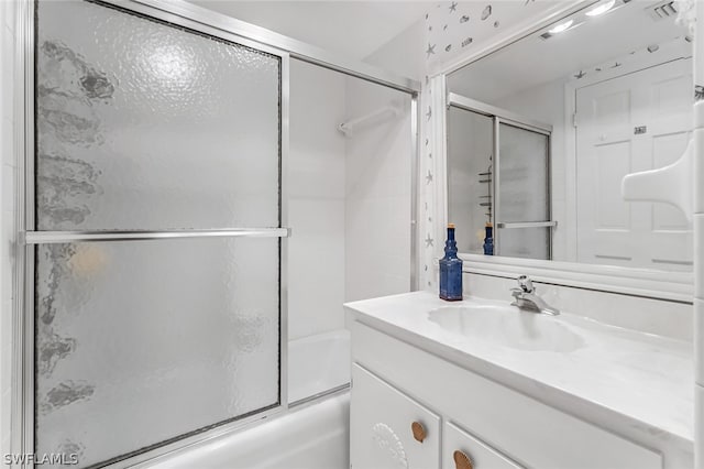 bathroom with vanity and combined bath / shower with glass door