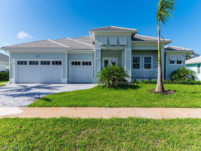 view of front of property featuring a garage and a front lawn