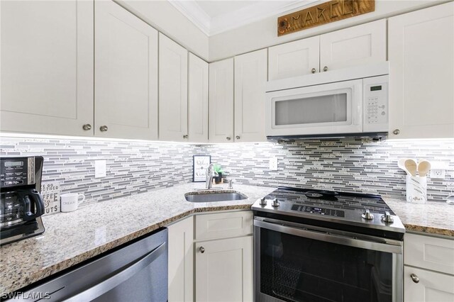 kitchen featuring white cabinetry, decorative backsplash, light stone counters, and stainless steel appliances