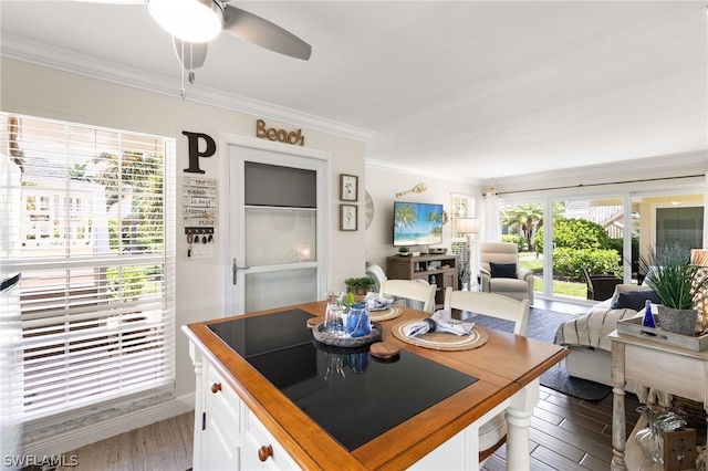 kitchen featuring ceiling fan, white cabinetry, crown molding, and dark wood-type flooring