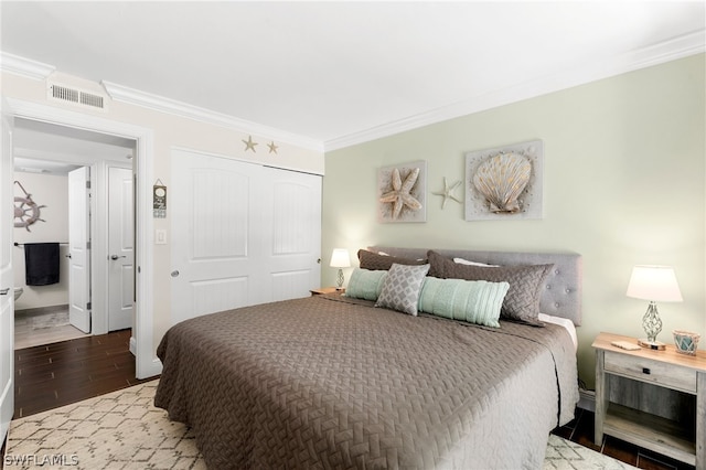 bedroom featuring a closet, light wood-type flooring, and ornamental molding