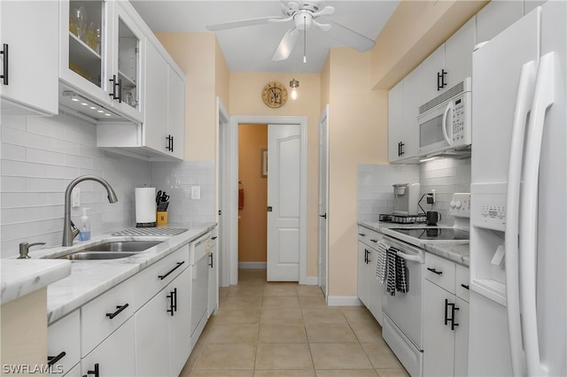 kitchen featuring ceiling fan, tasteful backsplash, white appliances, and white cabinets