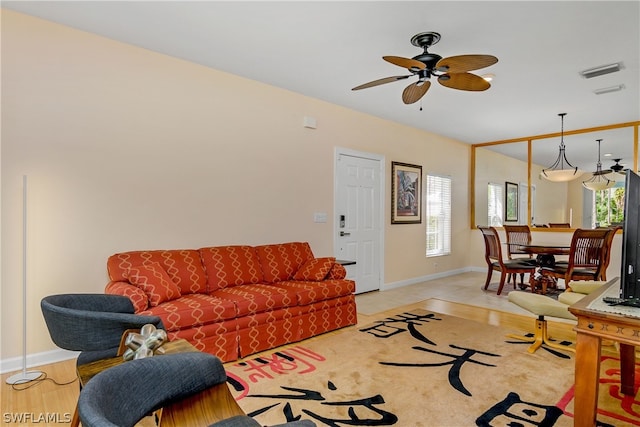 tiled living room featuring ceiling fan