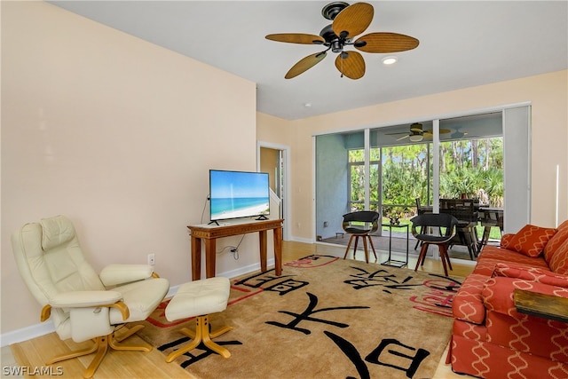 living room with light hardwood / wood-style floors and ceiling fan