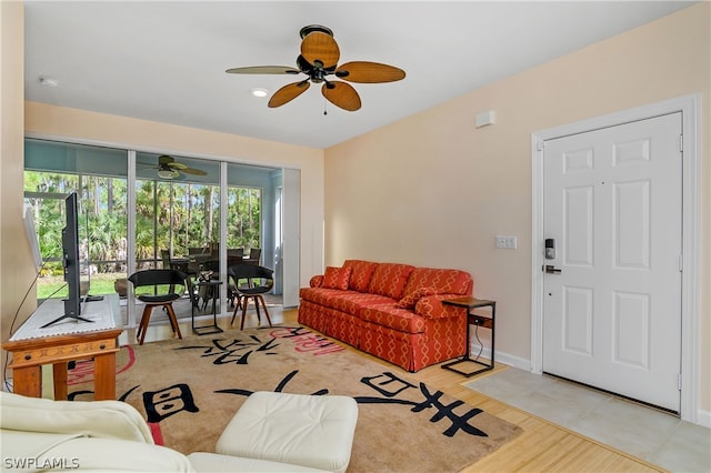 living room with a healthy amount of sunlight, light hardwood / wood-style flooring, and ceiling fan