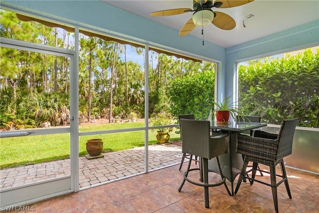 sunroom featuring ceiling fan