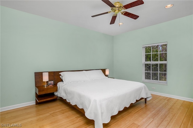 bedroom featuring light wood-type flooring and ceiling fan