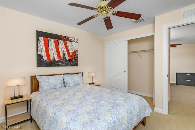 bedroom featuring light carpet, ceiling fan, and a closet