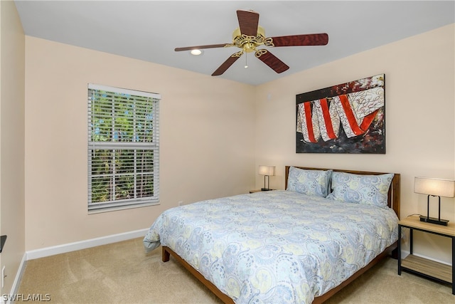 bedroom with light carpet and ceiling fan