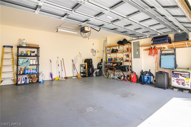 garage with a garage door opener and electric panel