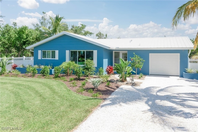 ranch-style home with a garage and a front lawn