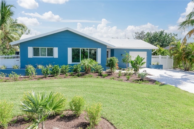 view of front of house with a garage and a front yard