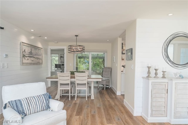 dining area featuring a chandelier and wood-type flooring