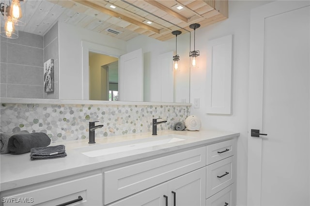 bathroom with decorative backsplash, beamed ceiling, vanity, and wood ceiling