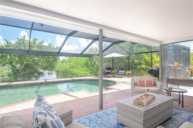 view of pool with glass enclosure, a patio area, an outdoor hangout area, and a water view