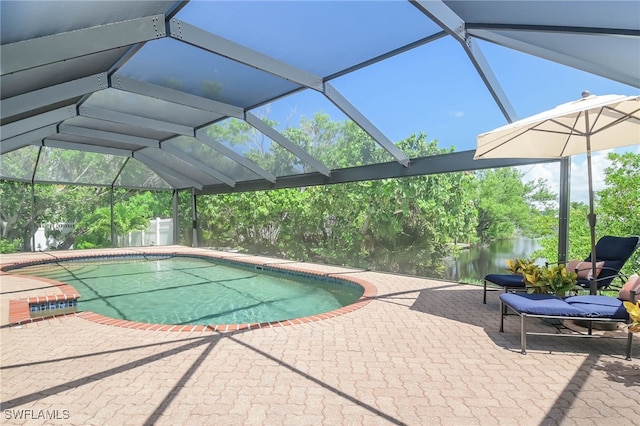 view of swimming pool featuring a water view, a lanai, and a patio area