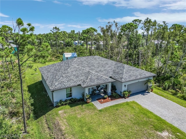 ranch-style home with a garage and a front lawn