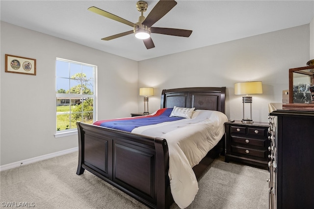 bedroom featuring light colored carpet and ceiling fan