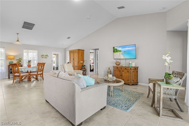 tiled living room with high vaulted ceiling