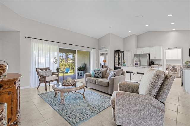 tiled living room featuring washer / clothes dryer and high vaulted ceiling