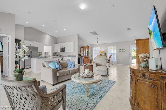 living room featuring lofted ceiling and light tile patterned floors