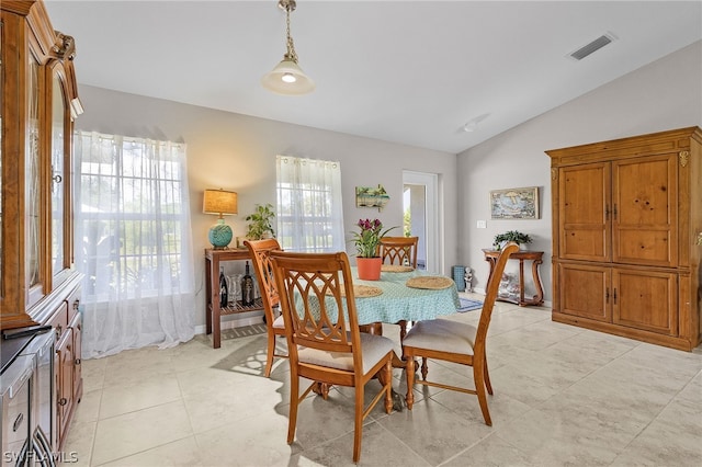 dining space featuring a wealth of natural light and vaulted ceiling