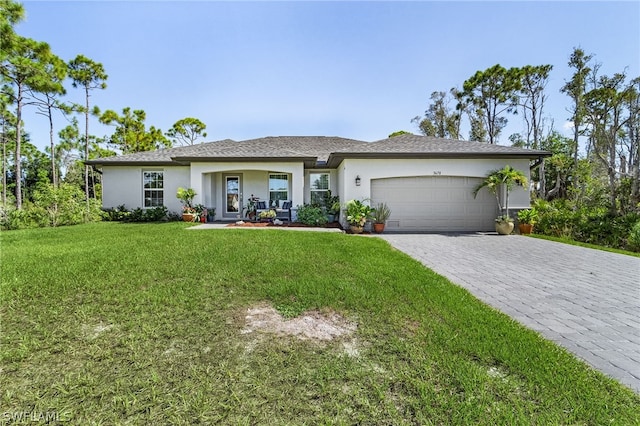 view of front of house featuring a garage and a front lawn