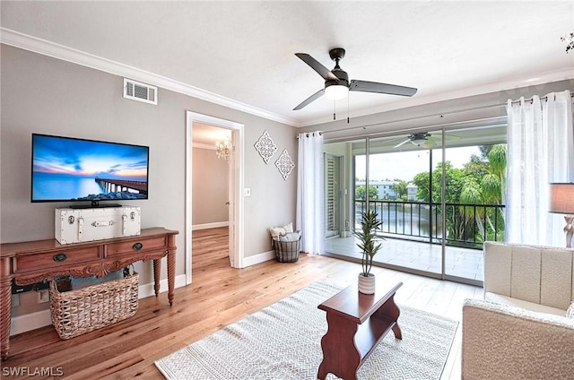 living room with crown molding, ceiling fan, and hardwood / wood-style floors