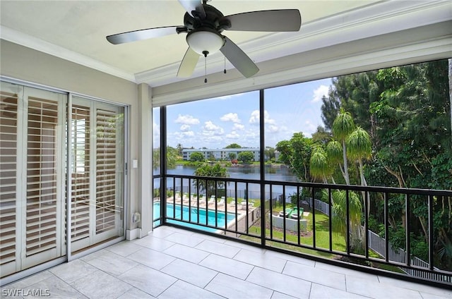 unfurnished sunroom with ceiling fan and a water view