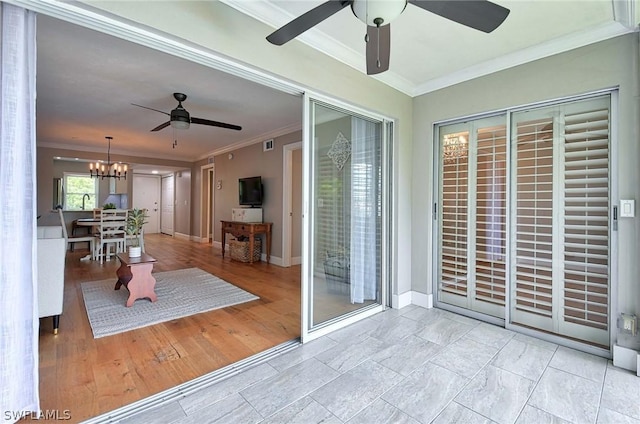 interior space featuring ceiling fan with notable chandelier