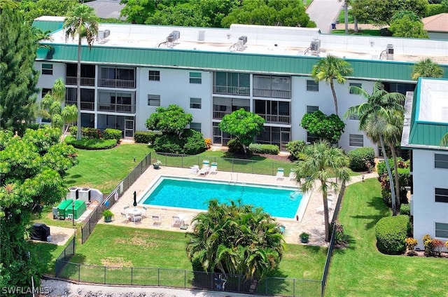 view of pool with a patio and a yard