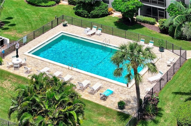 view of pool featuring a patio area and a lawn