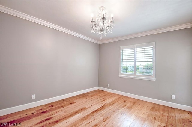 empty room with an inviting chandelier, wood-type flooring, and ornamental molding