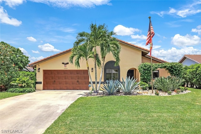 mediterranean / spanish home with a front yard and a garage