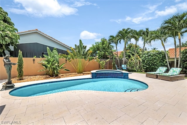 view of pool with an in ground hot tub and a patio area