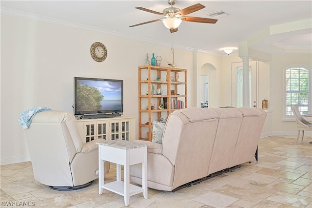 living room featuring ceiling fan, ornamental molding, and ornate columns