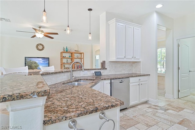 kitchen featuring dishwasher, sink, white cabinets, and kitchen peninsula